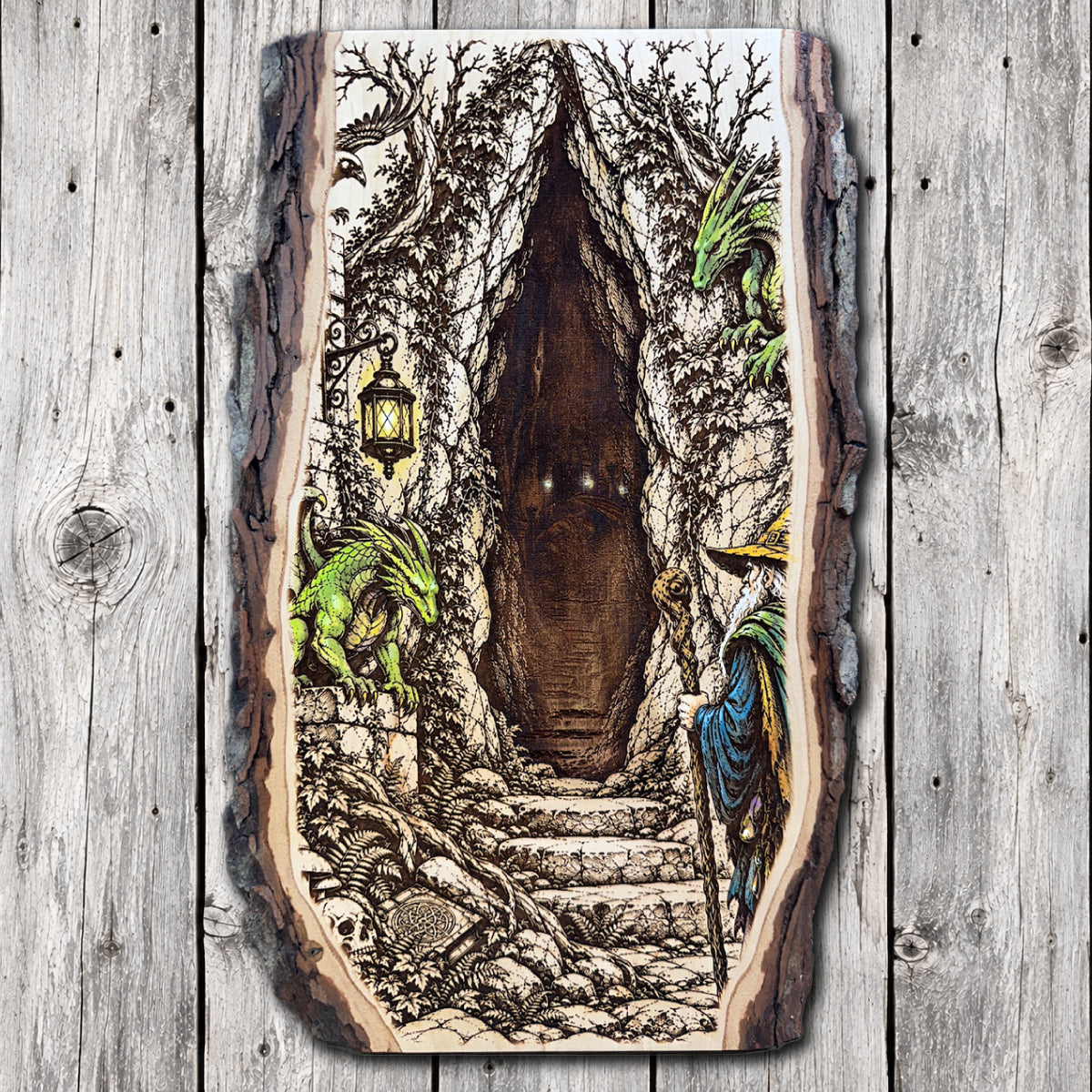 Hand-painted live edge wood wall art featuring two green dragons guarding a mysterious stone cavern entrance, with a wizard holding a staff beside ancient steps and a glowing lantern.