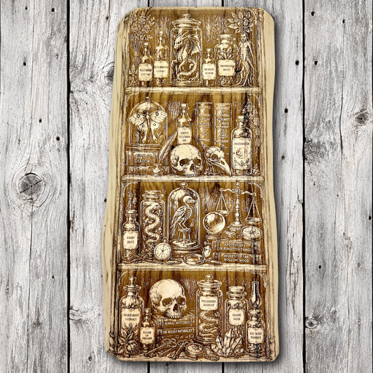 Handcrafted live edge wood wall art featuring a detailed laser engraving of a mystical apothecary cabinet filled with potion bottles, skulls, spellbooks, preserved creatures, and magical artifacts.