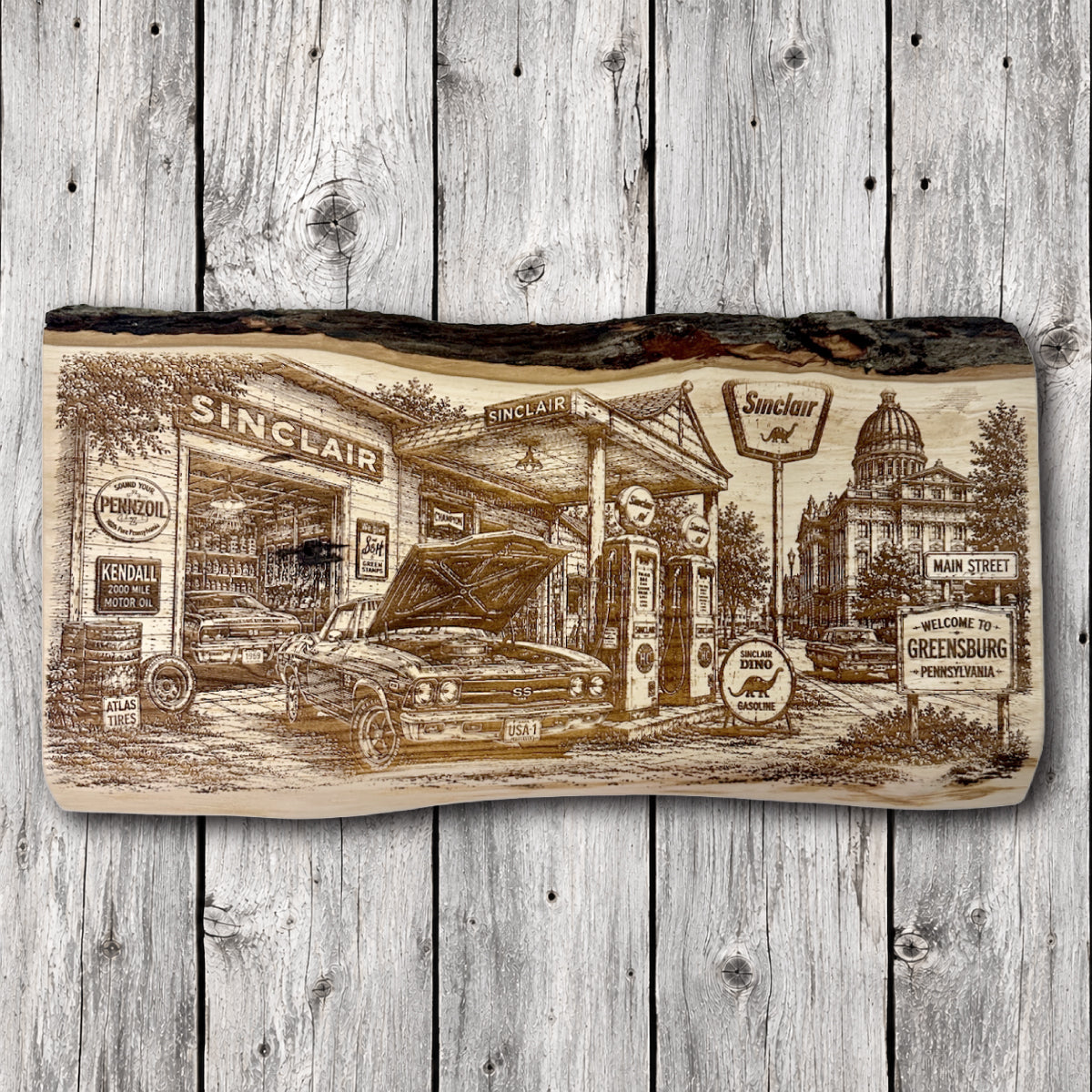 Handcrafted live edge engraved wood wall art depicting a vintage Sinclair gas station in Greensburg, Pennsylvania, featuring a classic Chevrolet Chevelle SS, antique gas pumps, retro automotive signs, and a historic downtown streetscape.