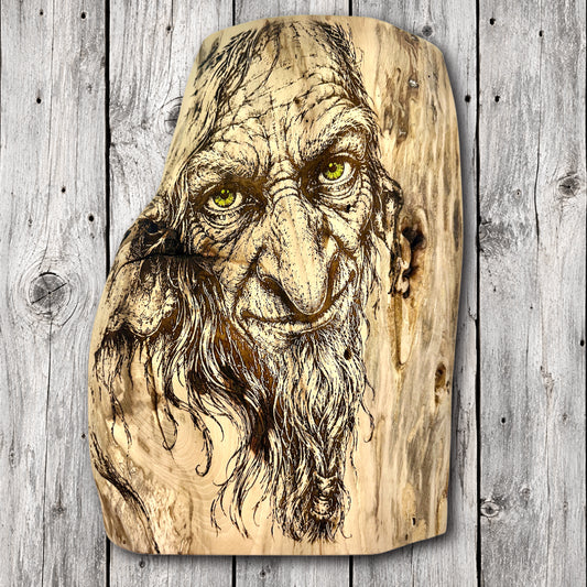 Mischievous woodland gremlin with crooked nose, expressive eyes, and long tangled beard laser engraved on natural live edge hardwood wall art.